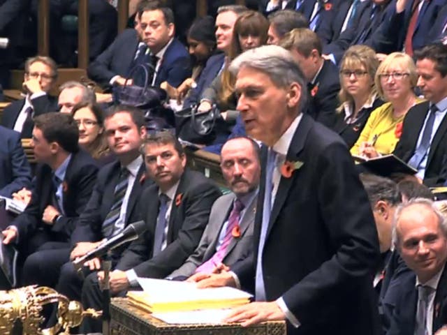Stacking it: Philip Hammond with the extensive Budget paperwork 