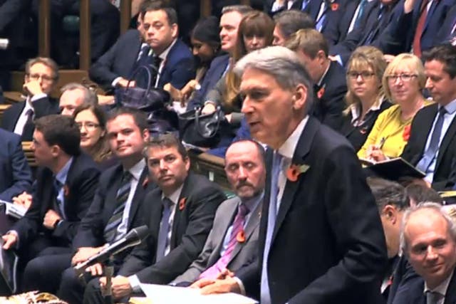 Stacking it: Philip Hammond with the extensive Budget paperwork 
