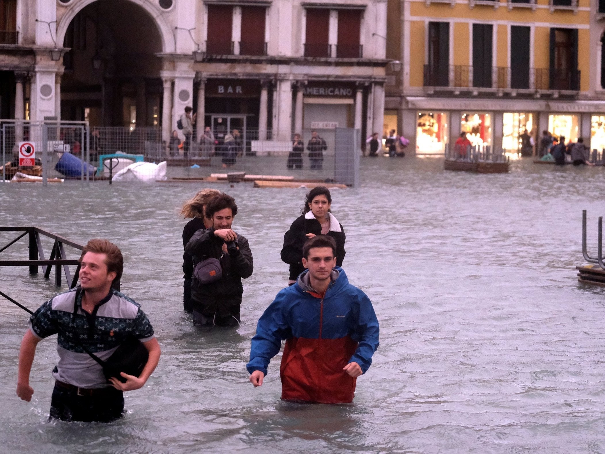 People walk in a flooded Saint Mark's Square