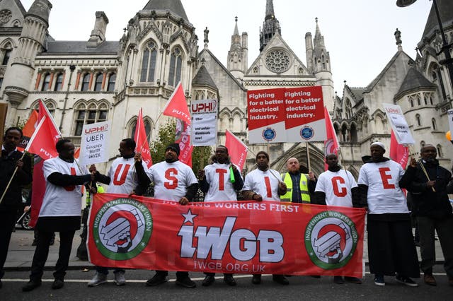 Uber drivers stage a protest outside the Royal Courts of Justice, London, before a ruling on their employment rights.