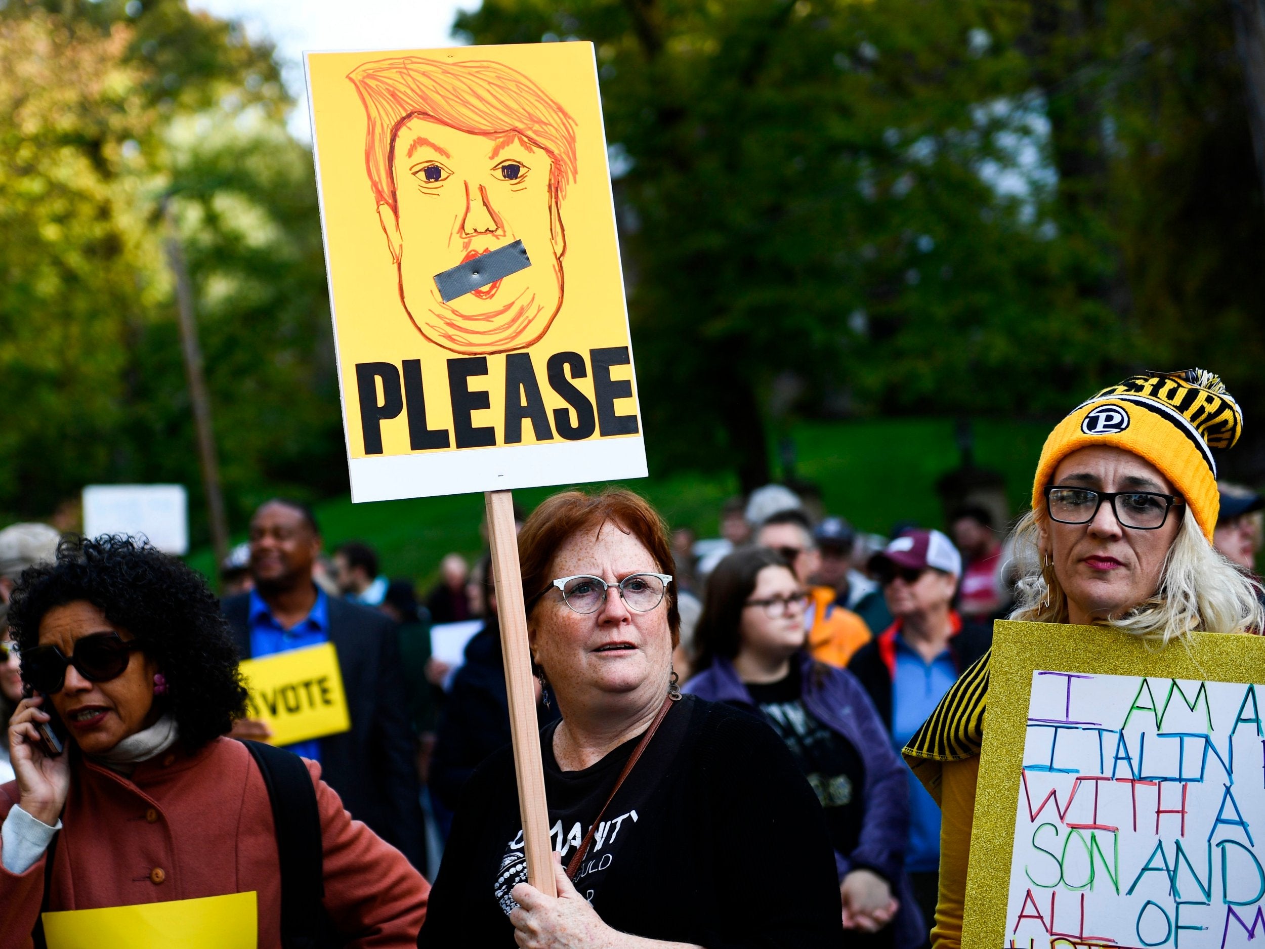 People protesting against US President Donald Trump wait near the Tree of Life Congregation in Pittsburgh on Tuesday evening