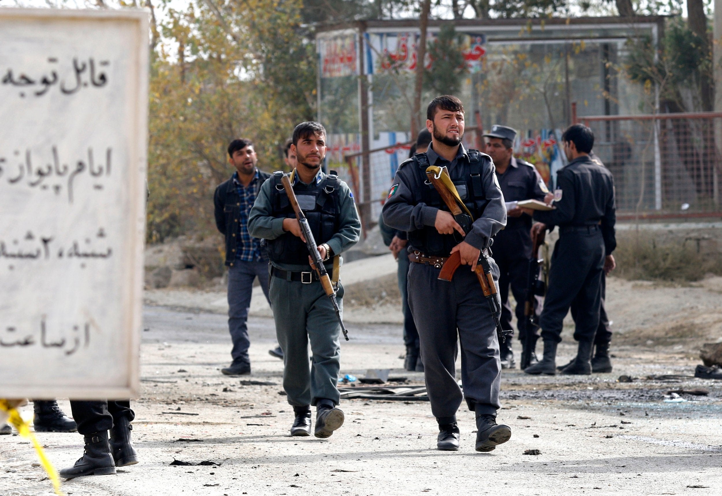 Afghan security officials inspect the scene of a suicide bomb attack in Kabul, Afghanistan on 31 October 2018