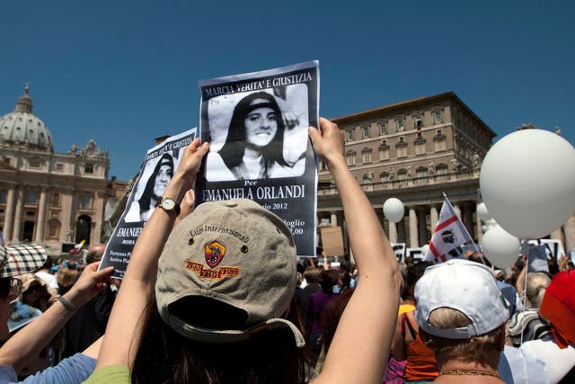 Demonstrators hold pictures of Emanuela Orlandi reading 'march for truth and justice for Emanuela' during Pope Benedict XVI's Regina Coeli prayer in St Peter's square, at the Vatican, in 2012