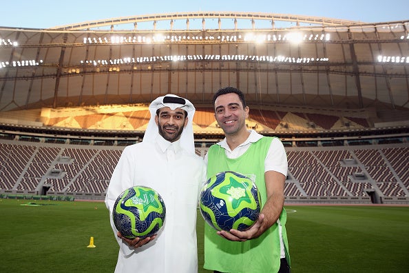 Xavi poses with Hassan Al Thawadi at a presentation in Qatar earlier this year