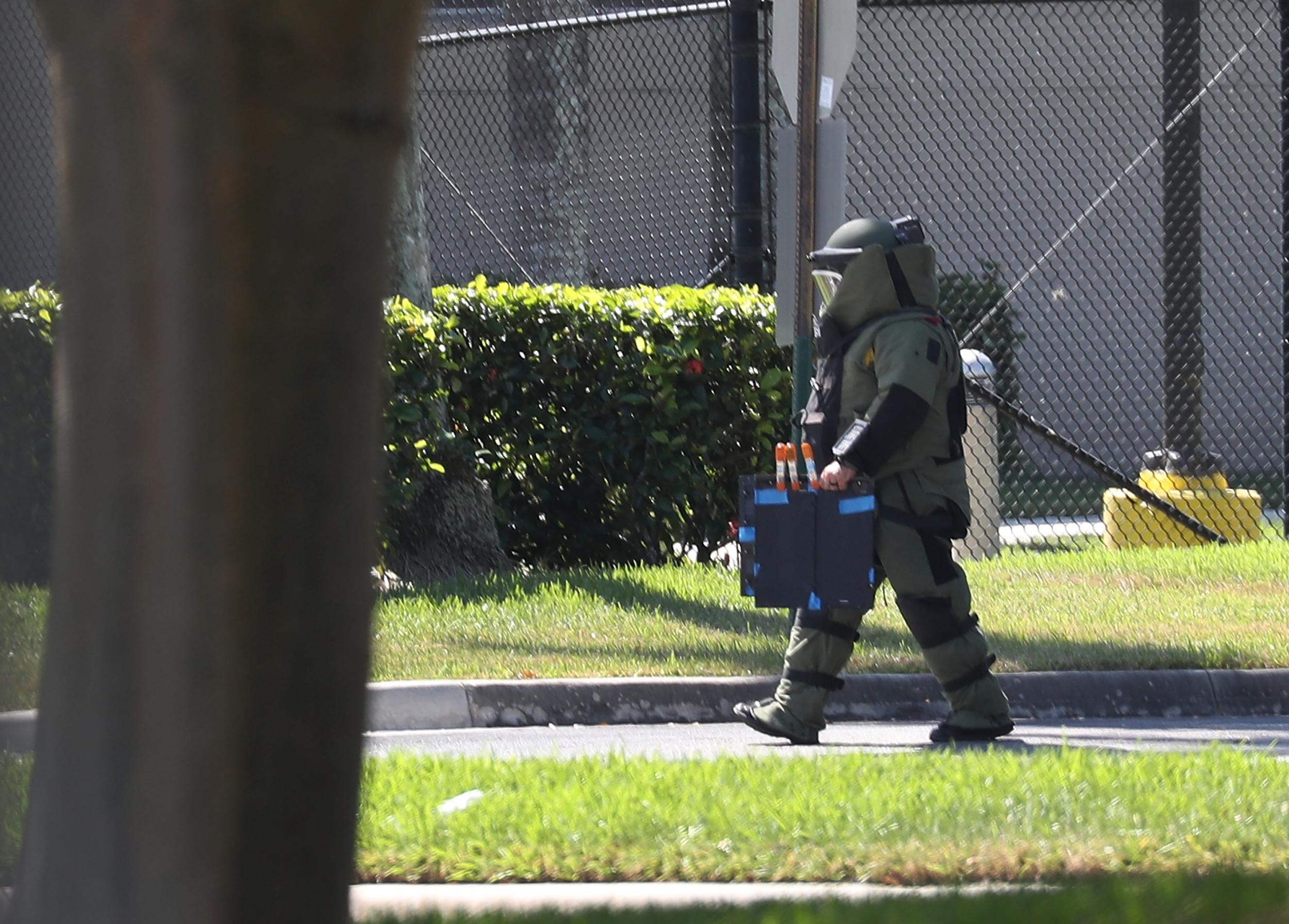 A member of the Broward Sheriff's Office bomb squad investigates a suspicious package in the building where House Democrat Debbie Wasserman Schultz has an office on 24 October 2018 in Sunrise, Florida.