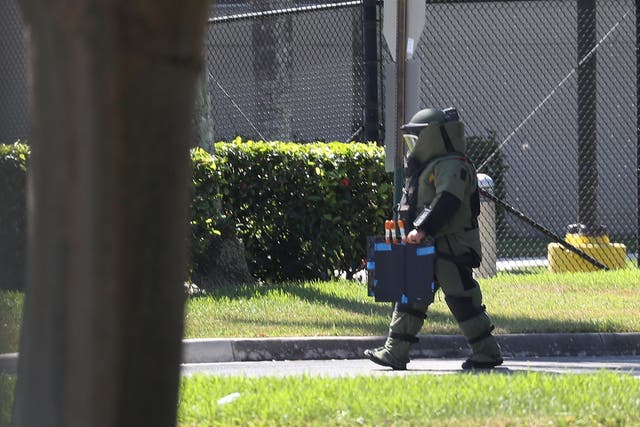 A member of the Broward Sheriff's Office bomb squad investigates a suspicious package in the building where House Democrat Debbie Wasserman Schultz has an office on 24 October 2018 in Sunrise, Florida.