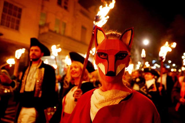 Participants carrying torches march during the traditional Bonfire Night celebrations in Lewes