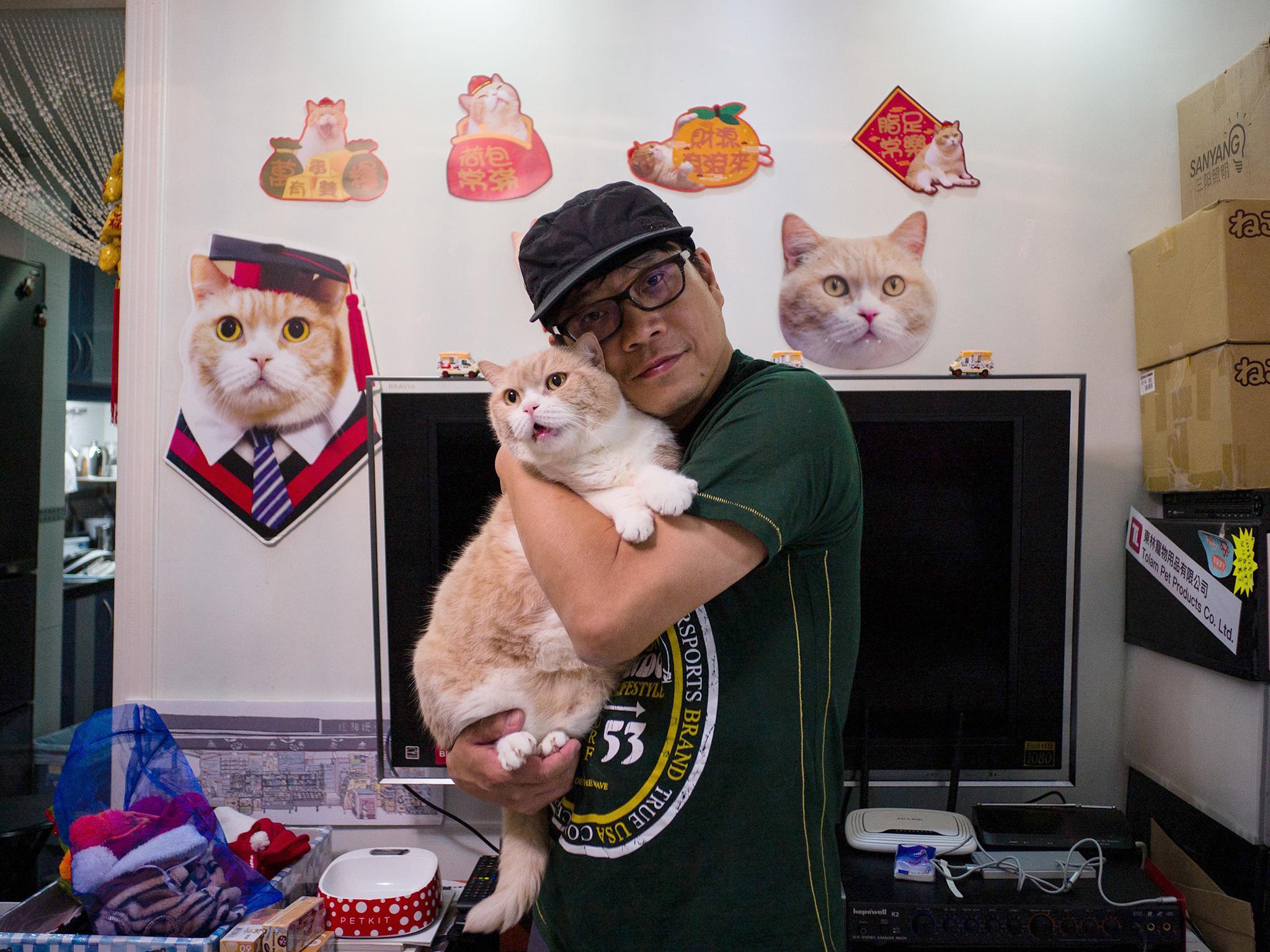 Ko Chee-shing poses with his cat Cream Brother in Hong Kong