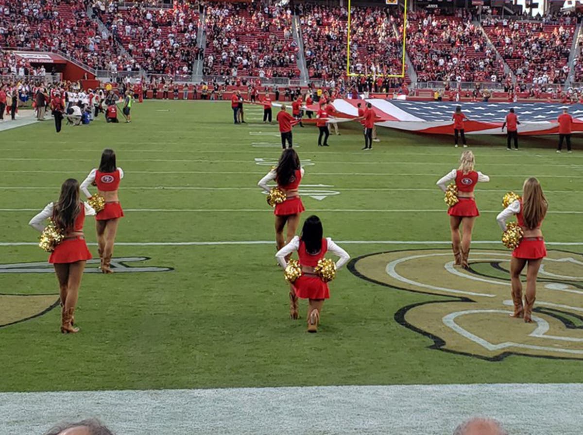 San Francisco 49ers cheerleader takes a knee during national anthem