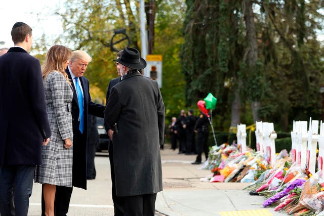 Donald Trump and Melania Trump talk with Rabbi Jeffrey Myers (back to camera) and Ron Dermer, Israel's ambassador to the United States, outside Pittsburgh's Tree of Life Synagogue in Pittsburgh