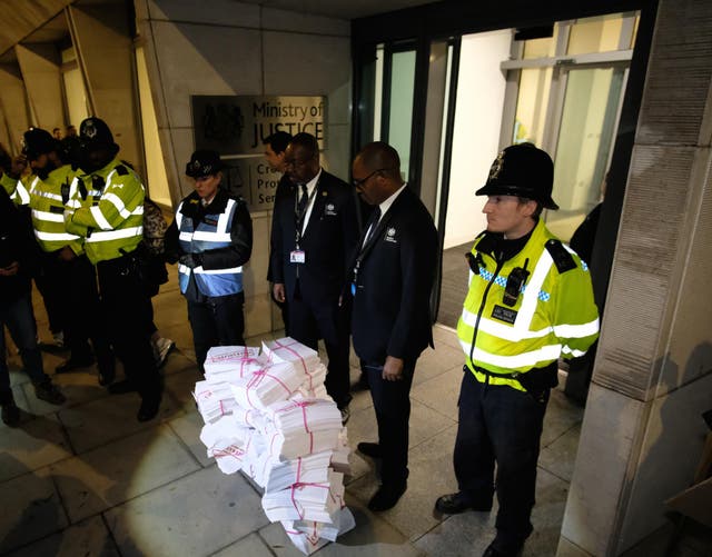 Protesters dumped documents representing rape victims' phone data outside the CPS' offices at a protest on Thursday