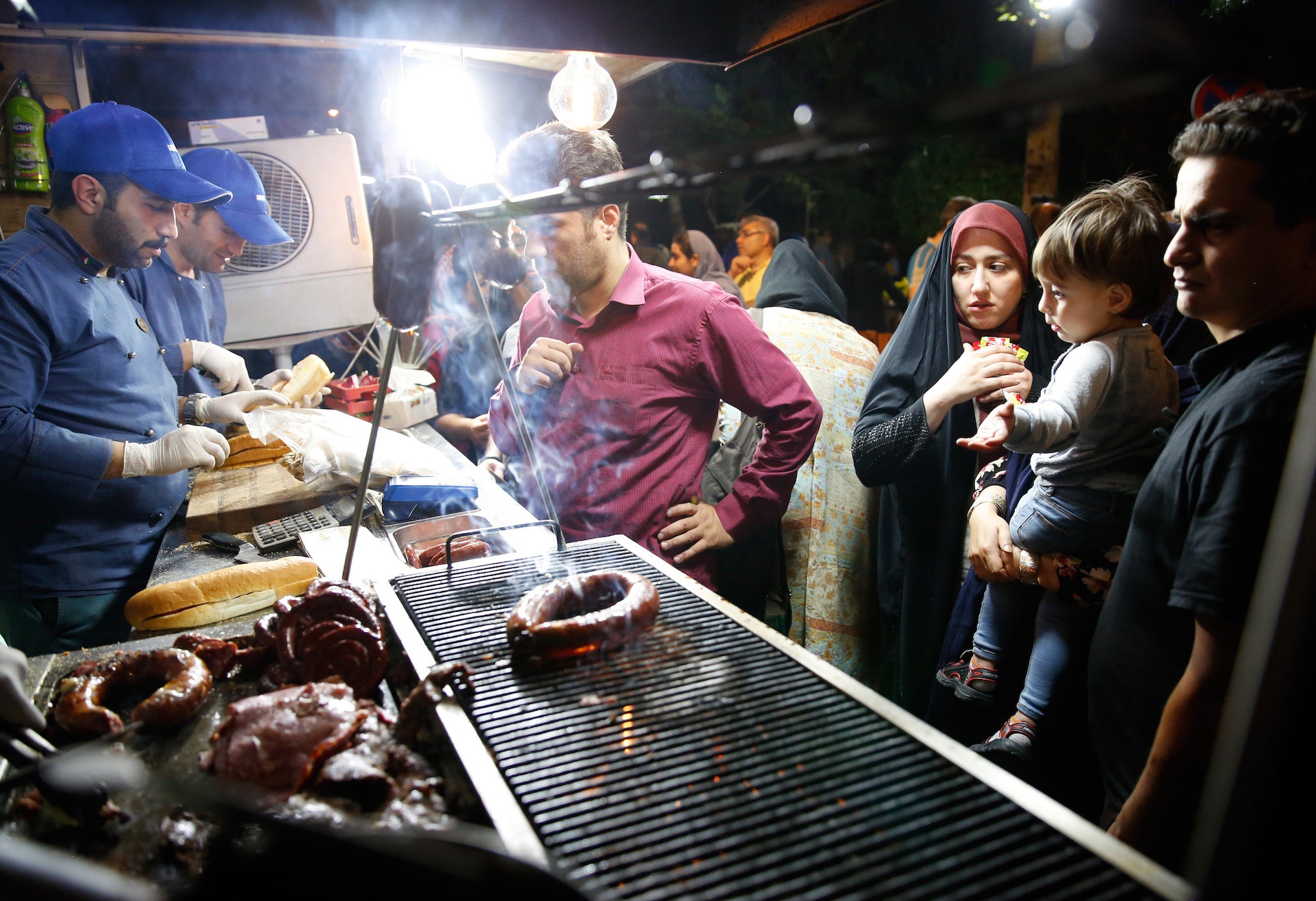 Iranians at a street food market in Tehran last month