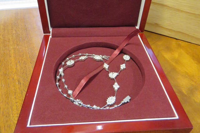 A diamond cluster and bar necklace was among 49 jewellery items seized by the National Crime Agency.