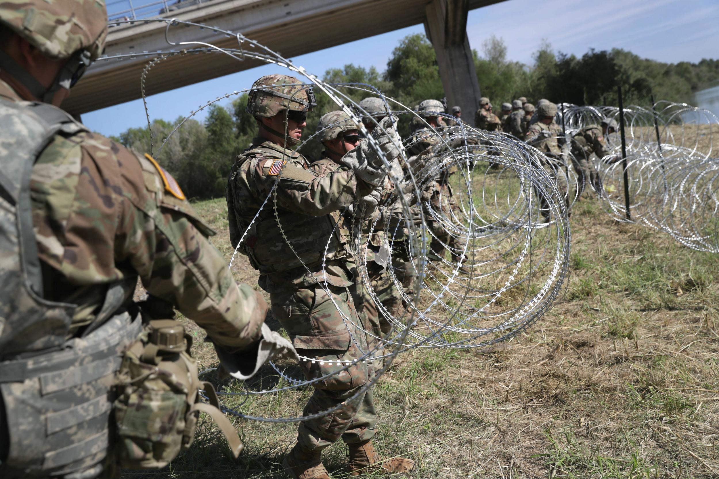US troops dispatched by Trump install razor wire on Mexico border in &apos;political stunt&apos; days ahead of midterm elections