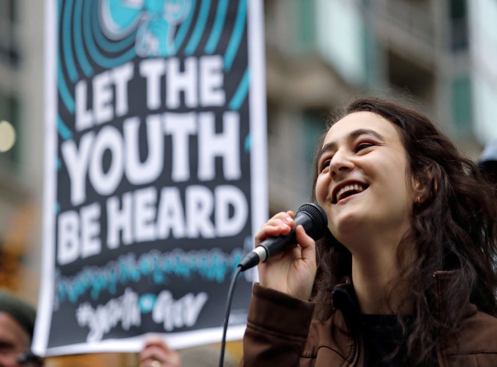 High school junior Jamie Margolin speaks during a rally by youth activists and others in support of the climate change lawsuit in Seattle