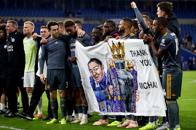 The Leicester players raise a banner to the away supporters at Cardiff