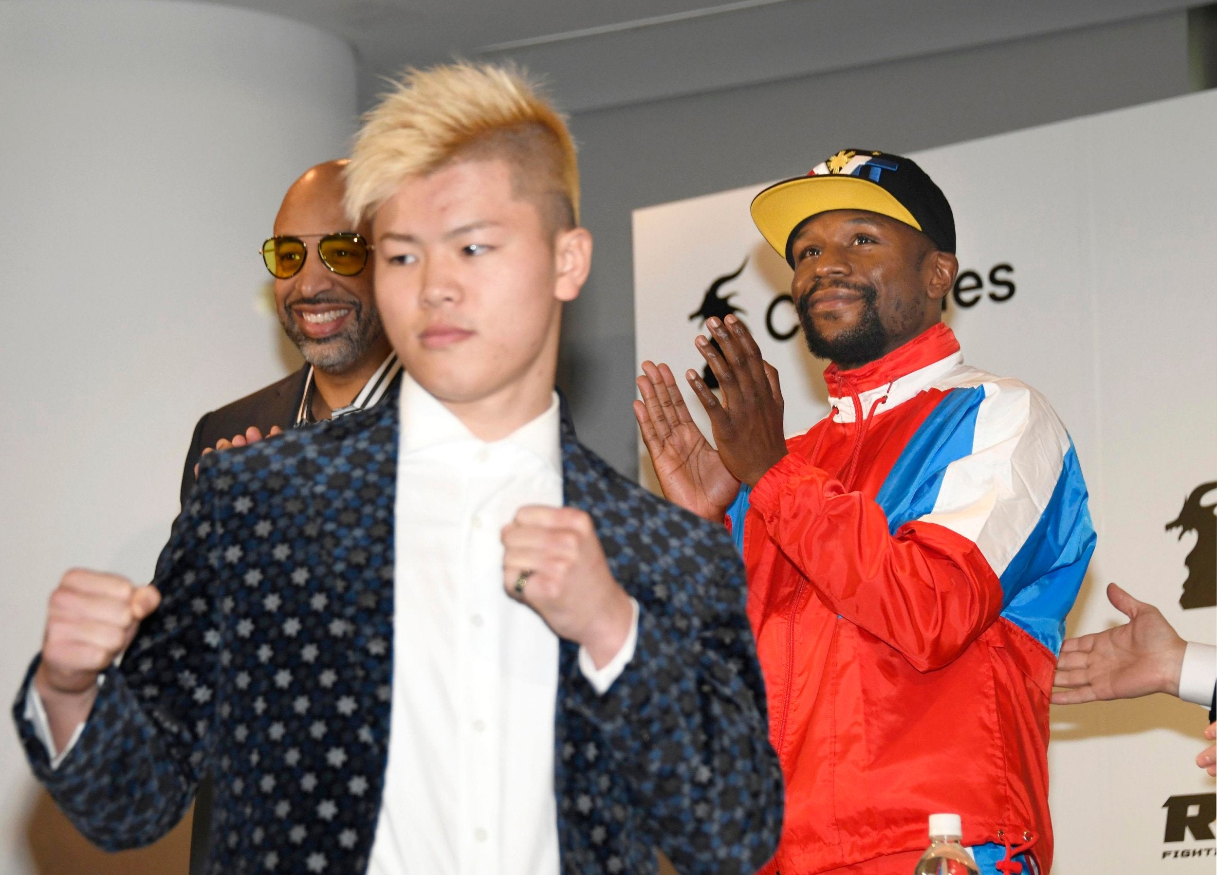 Mayweather claps as Nasukawa strikes a pose at the press conference