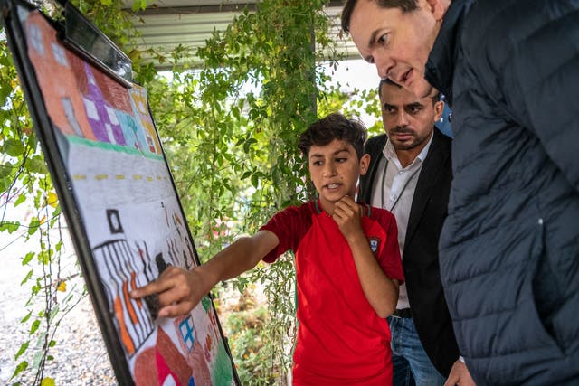 Ahmed, 12, explains his drawing to Editor of the Evening Standard George Osborne at a War Child centre in Kabarto camp for internally displaced persons in northern Iraq
