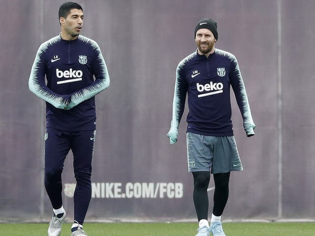 Barcelona's Lionel Messi and Luis Suarez attend a training session