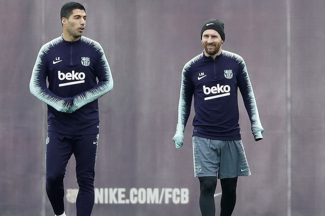 Barcelona's Lionel Messi and Luis Suarez attend a training session