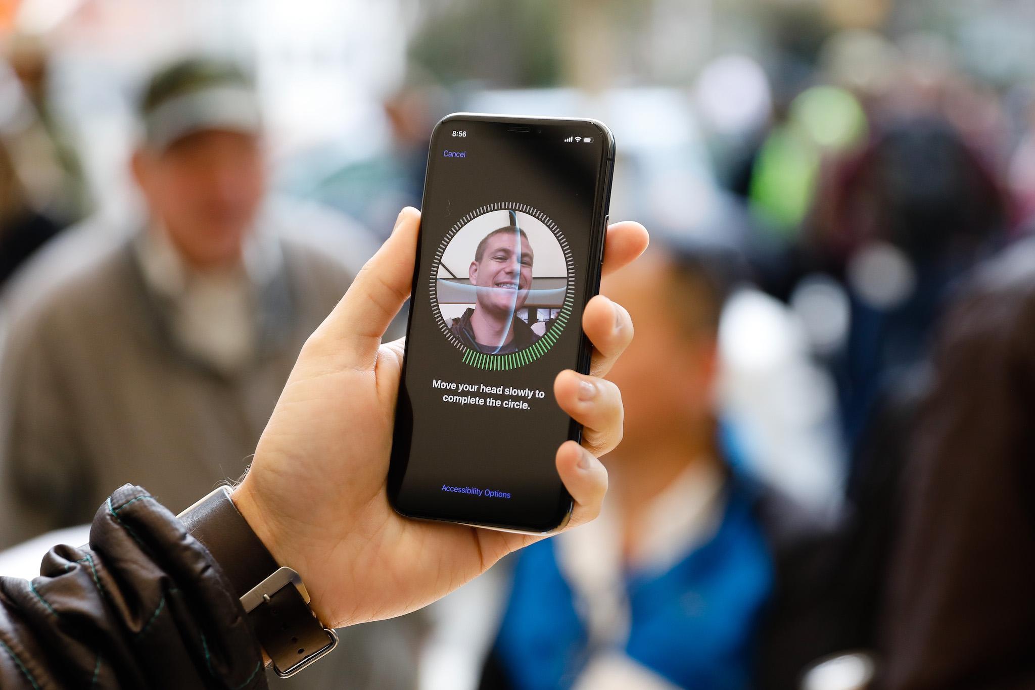 A customer sets up Face ID on his new iPhone X at the Apple Store Union Square on November 3, 2017, in San Francisco, California