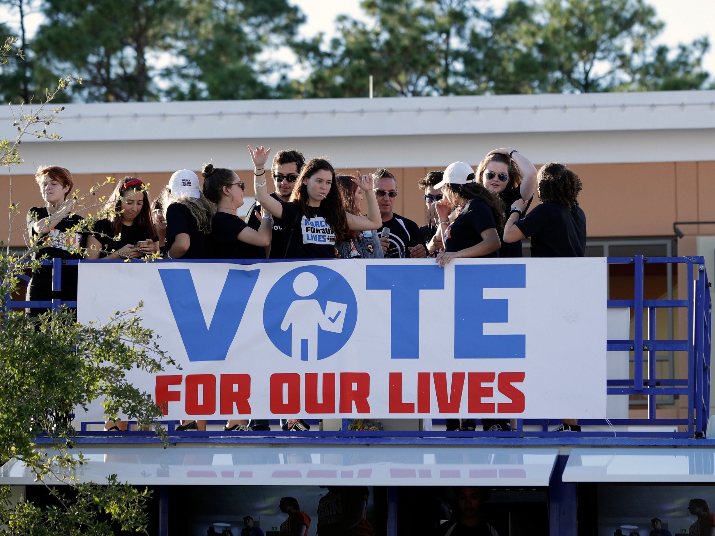 Students on top of a bus during a Vote for Our Lives rally at the University of Central Florida in Orlando