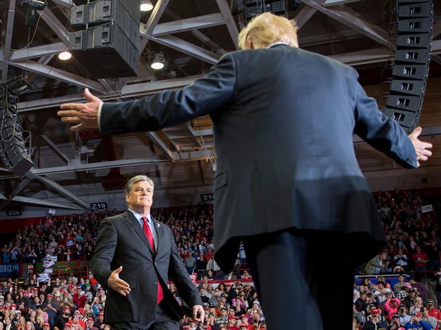 US President Donald Trump greets talk show host Sean Hannity at a Make America Great Again rally in Cape Girardeau, Missouri on November 5, 2018