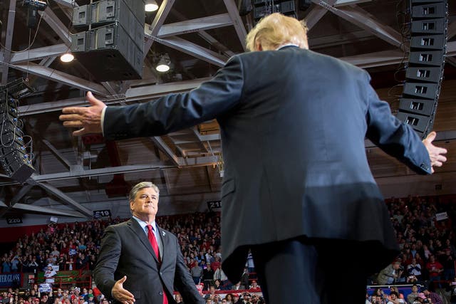 US President Donald Trump greets talk show host Sean Hannity at a Make America Great Again rally in Cape Girardeau, Missouri on November 5, 2018