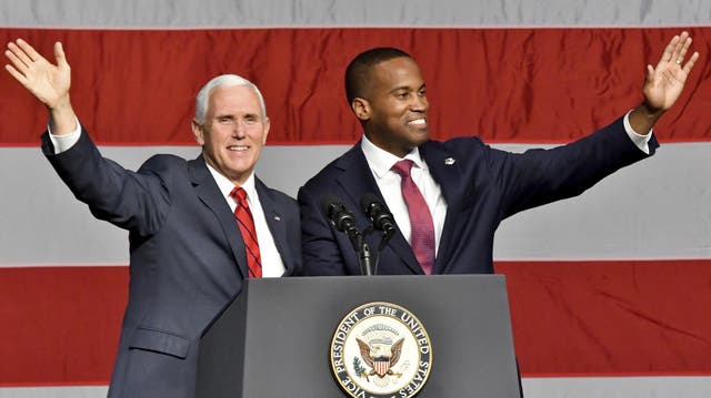 John James, right, and Vice President Mike Pence campaign with Republican candidates at the DeltaPlex in Grand Rapids on Monday, 29 October 2018