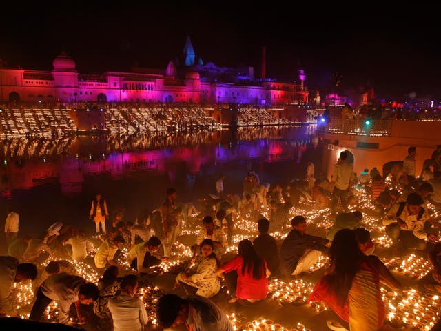 Devotees light earthen lamps on the banks of the River Sarayu as part of Diwali celebrations in Ayodhya, India