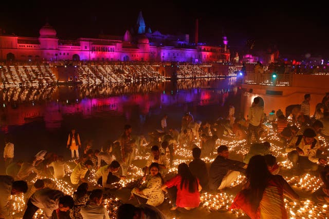 Devotees light earthen lamps on the banks of the River Sarayu as part of Diwali celebrations in Ayodhya, India