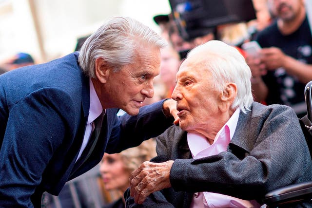 Actor Kirk Douglas (R) attends a ceremony honouring his son actor Michael Douglas (L) with a Star on the Hollywood Walk of Fame in Hollywood, California