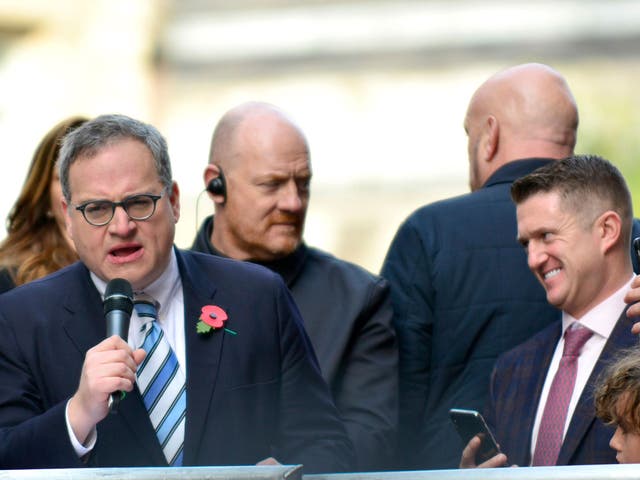 Ezra Levant (left) speaks on a stage outside the Old Bailey in support of Tommy Robinson (right) on 23 October
