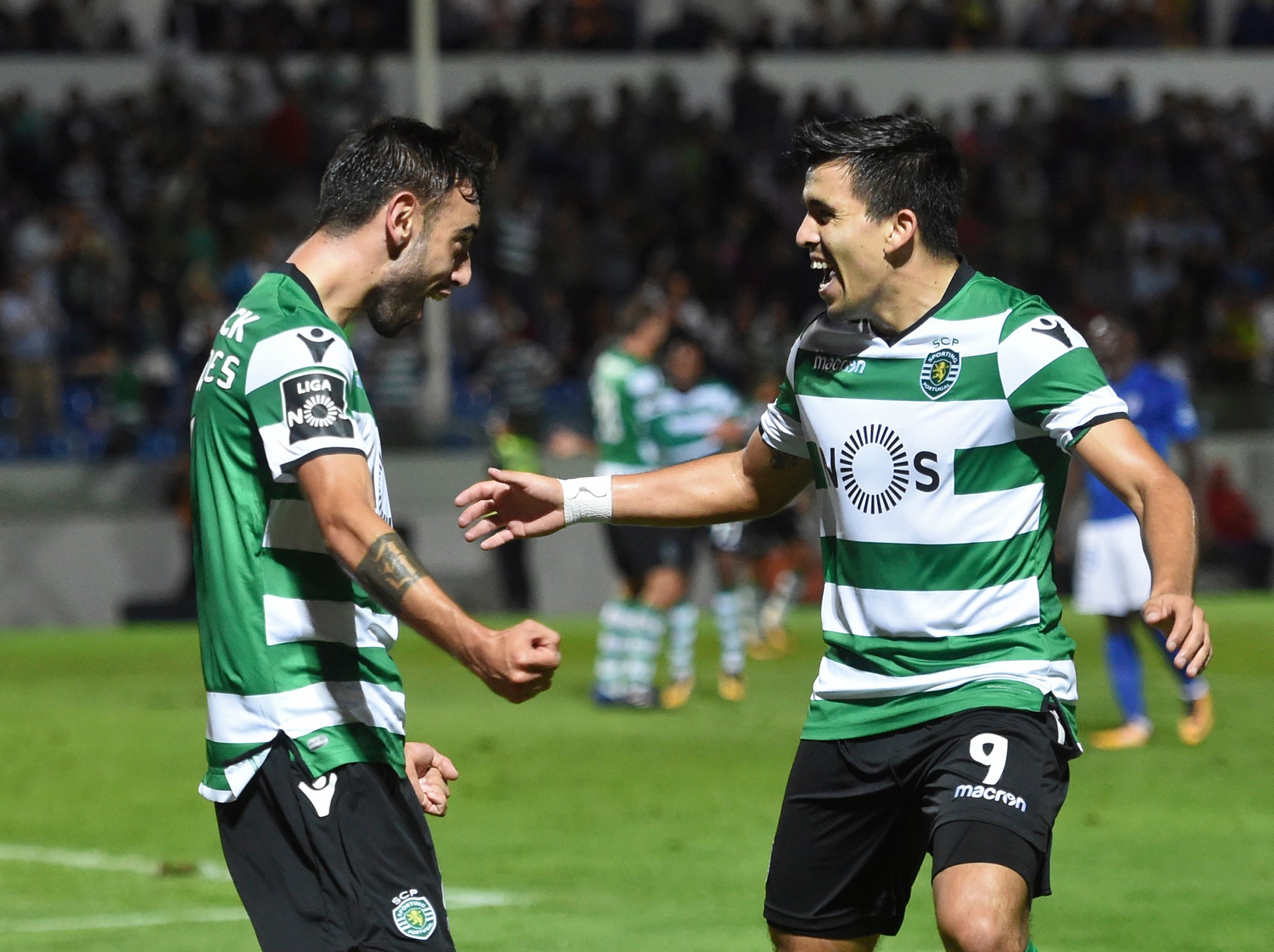 Bruno Fernandes (L) celebrates with Marcos Acuna