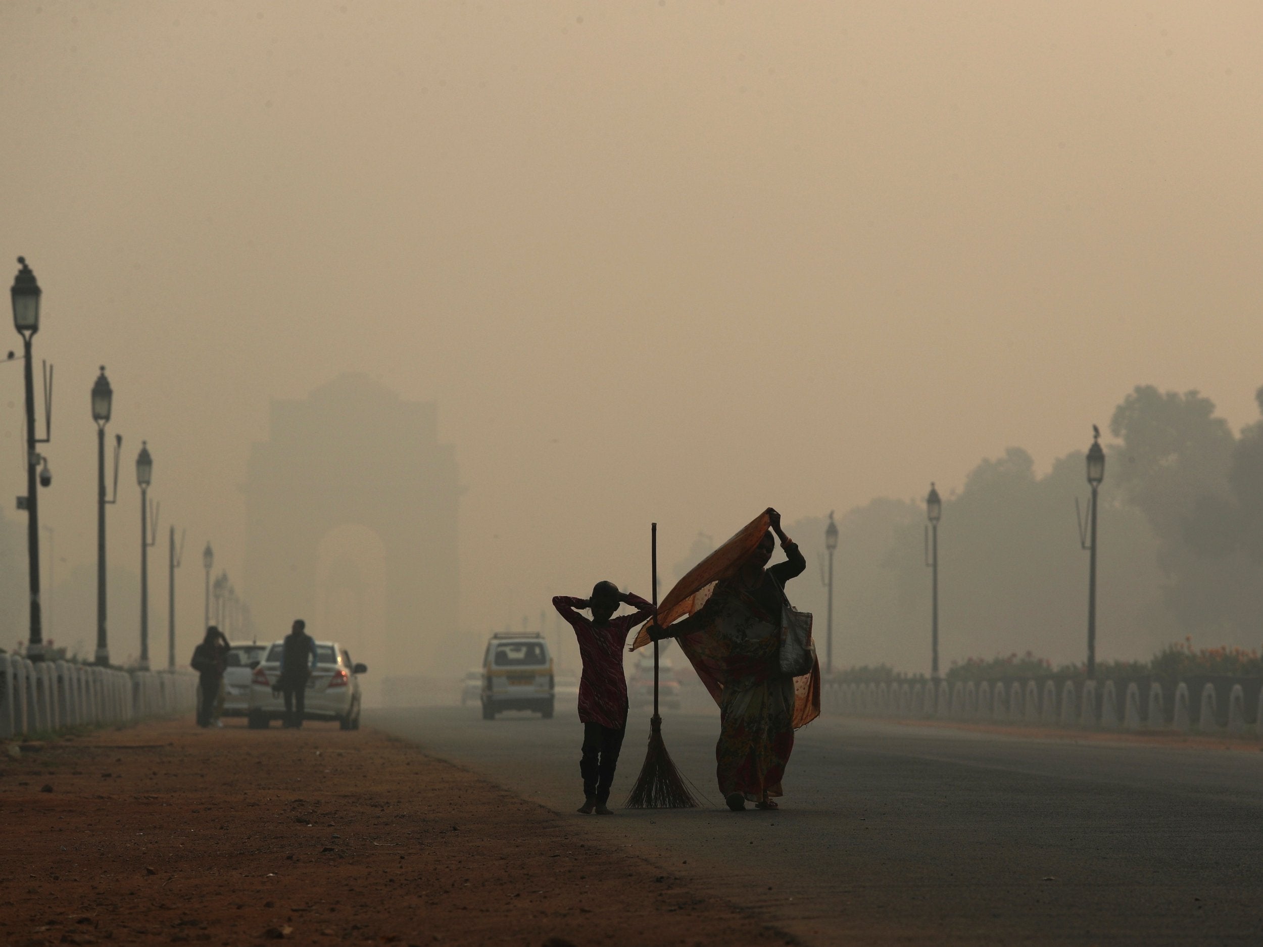 India Gate sits under a thick layer of pollution haze the morning after Diwali festival in Delhi