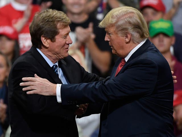 US President Donald Trump greets Jason Lewis, Republican US Congressman from Minnesota's 2nd district, at a campaign rally on October 4, 2018