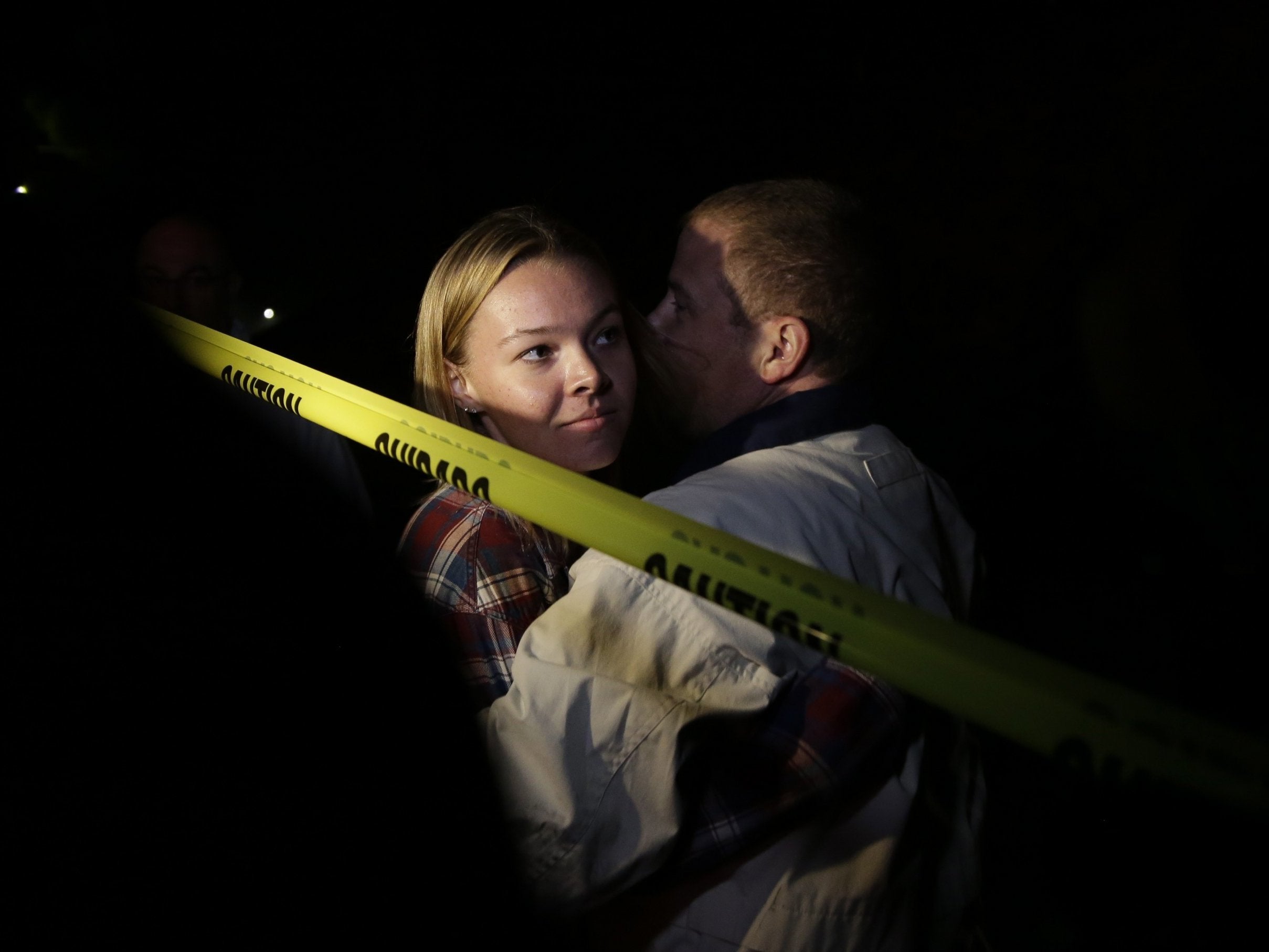Teylor Whittler is hugged by her father after she fled the Borderline Bar