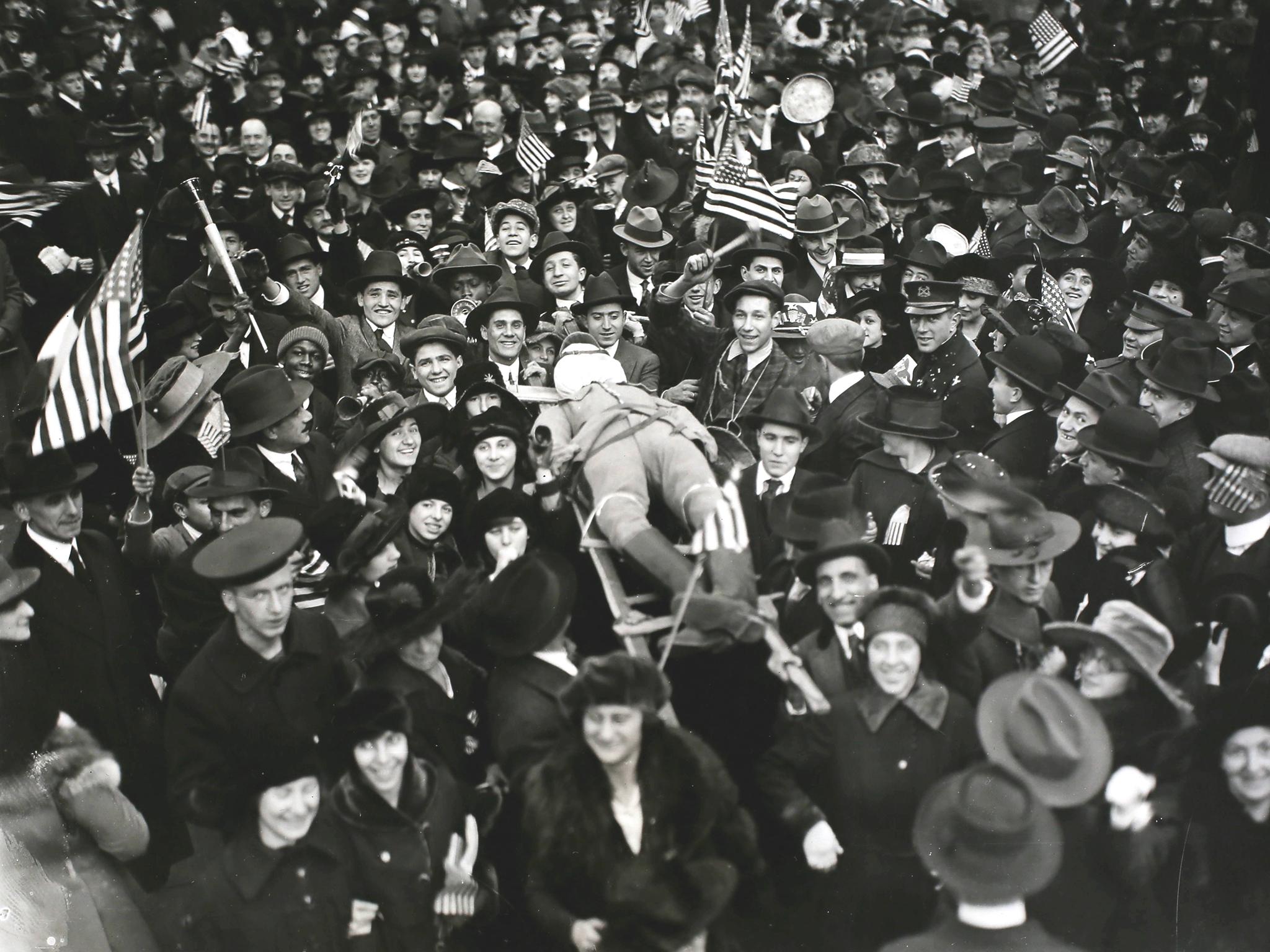 An effigy of the ex-Kaiser Wilhelm is carried aloft as crowds in New York City celebrate the signing of the armistice