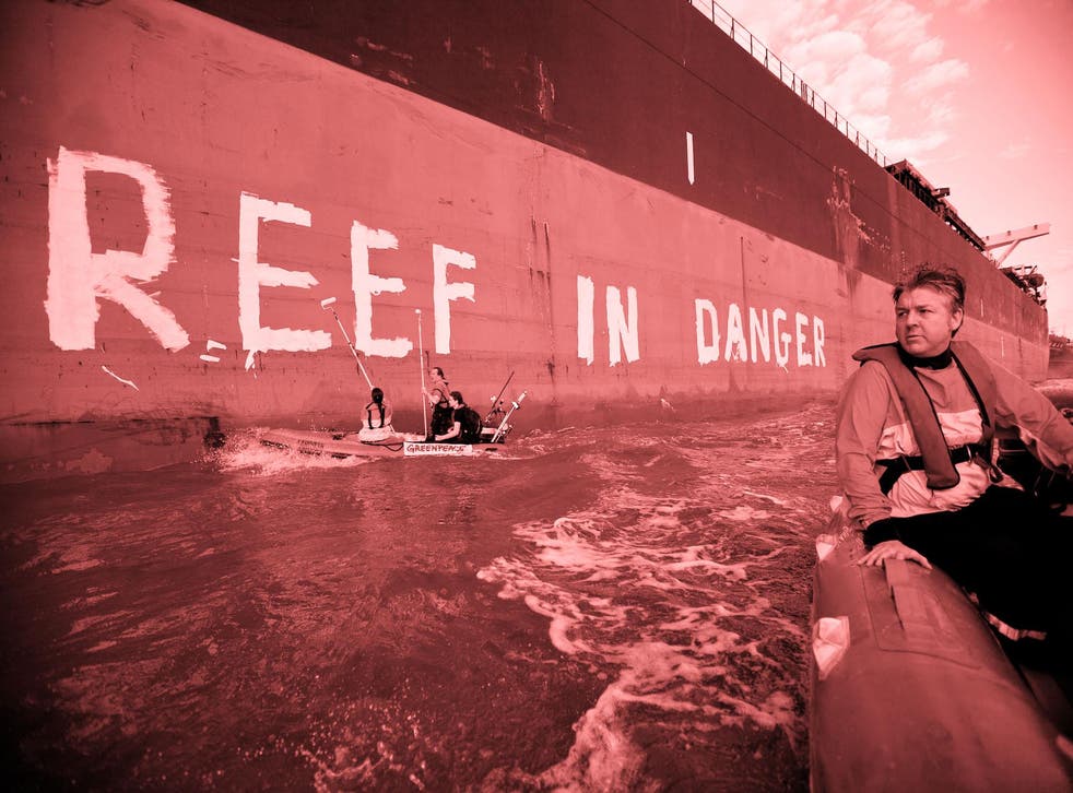 In this handout photo provided by Greenpeace, Activists paint the message "Reef in Danger" on the side of coal ship Chou San on March 7, 2012 in Gladstone, Australia
