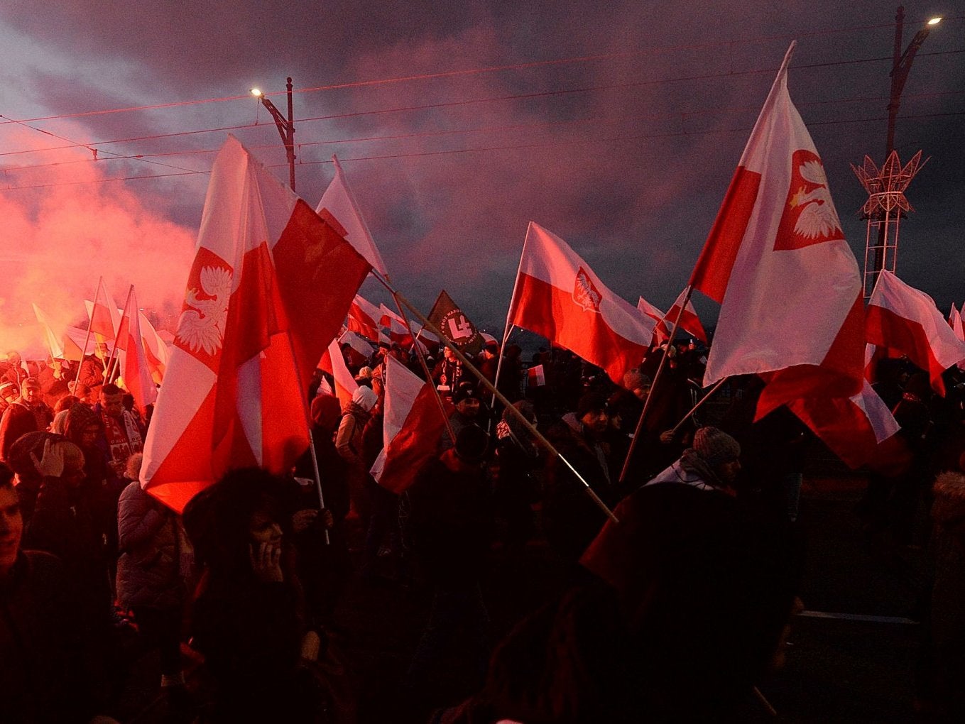 Demonstrators burn flares and wave Polish flags during the annual march to commemorate the country's self-determination