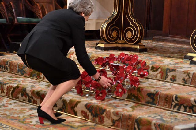 Theresa May, lays a wreath at an Armistice remembrance service at St Margaret's Church, in London, November 6, 2018