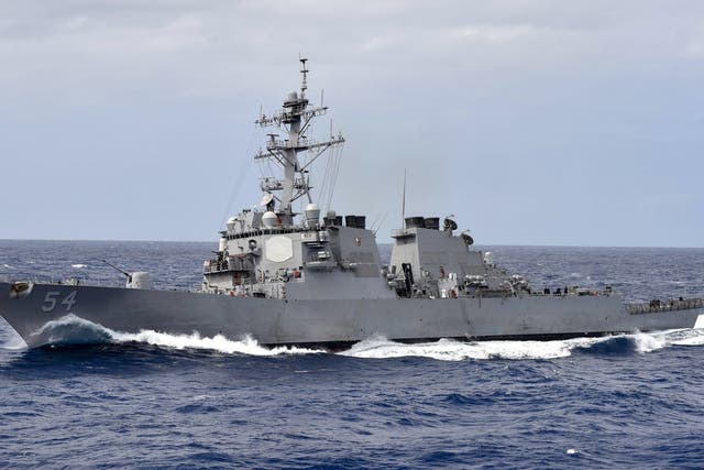 This US Navy photo shows the Arleigh Burke-class guided-missile destroyer USS Curtis Wilbur (DDG 54) as it participates in a close quarters maneuvering exercise on February 28, 2018 in the Philippine Sea