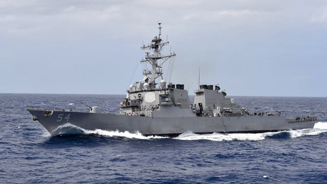 This US Navy photo shows the Arleigh Burke-class guided-missile destroyer USS Curtis Wilbur (DDG 54) as it participates in a close quarters maneuvering exercise on February 28, 2018 in the Philippine Sea