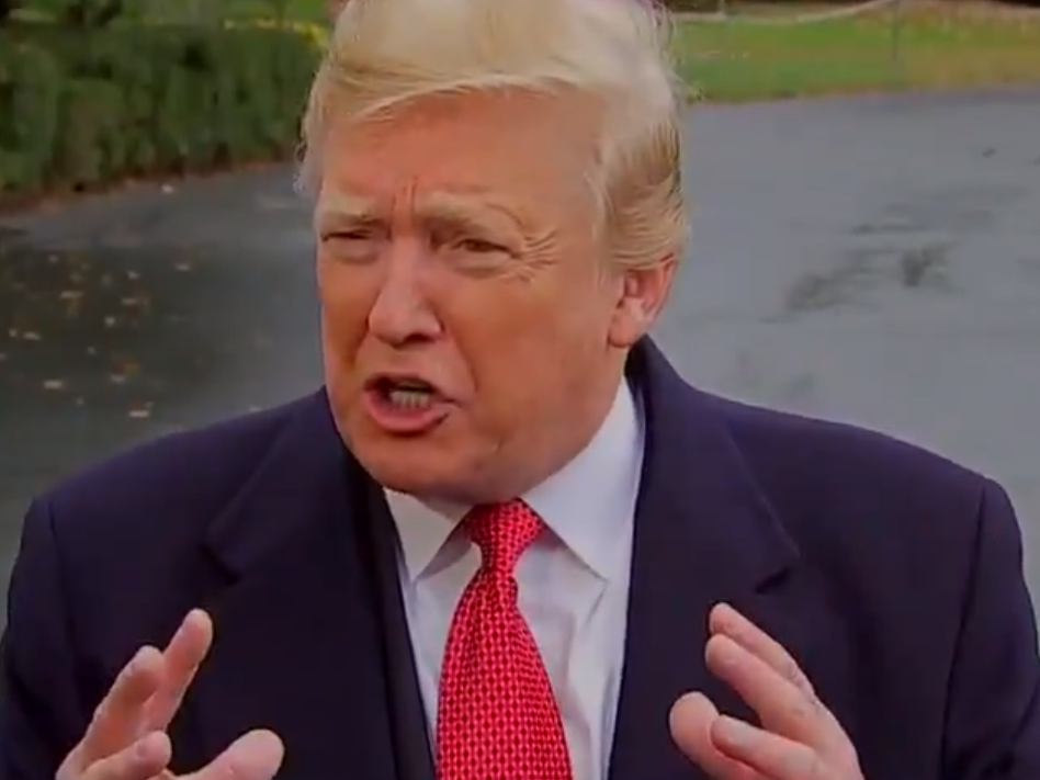 Donald Trump responds to reporters outside the White House