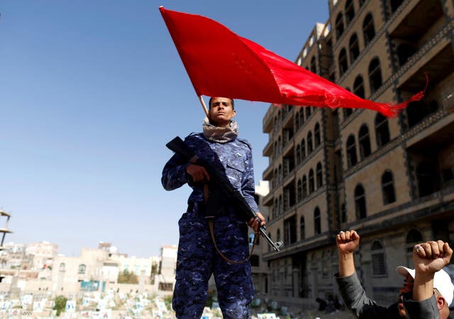 Houthi fighter stands guard at the site of a rally attended by fellows Houthis to mark the day of Ashura and the 4th anniversary of their takeover of the Yemeni capital, in Sanaa