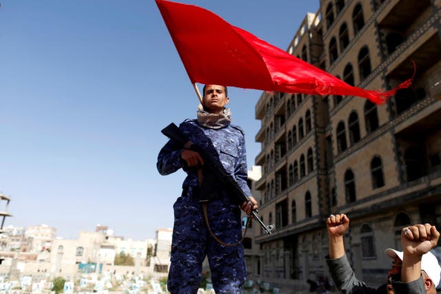 Houthi fighter stands guard at the site of a rally attended by fellows Houthis to mark the day of Ashura and the 4th anniversary of their takeover of the Yemeni capital, in Sanaa