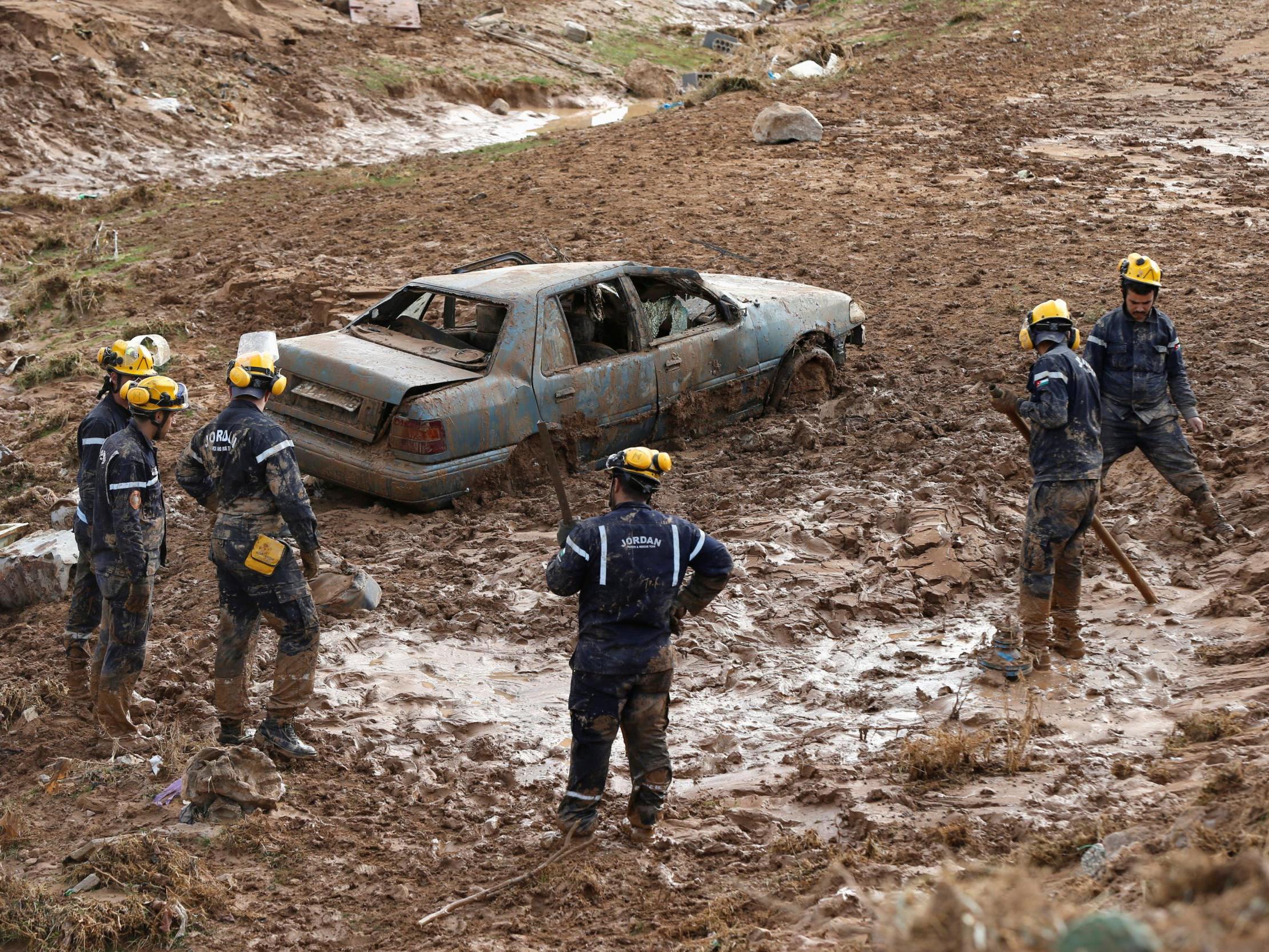 Civil defense members look for missing persons after rain storms unleashed flash floods, in Madaba city, near Amman, Jordan, November 10, 2018