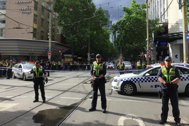 Policemen block members of the public from walking towards the Bourke Street mall in central Melbourne, Australia, November 9, 2018.