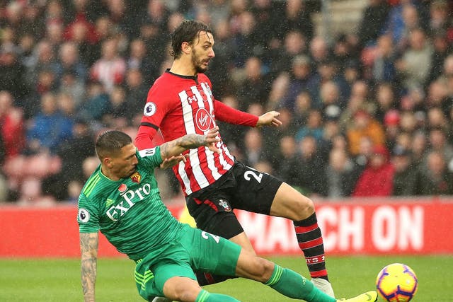 Manolo Gabbiadini is challenged by Jose Holebas