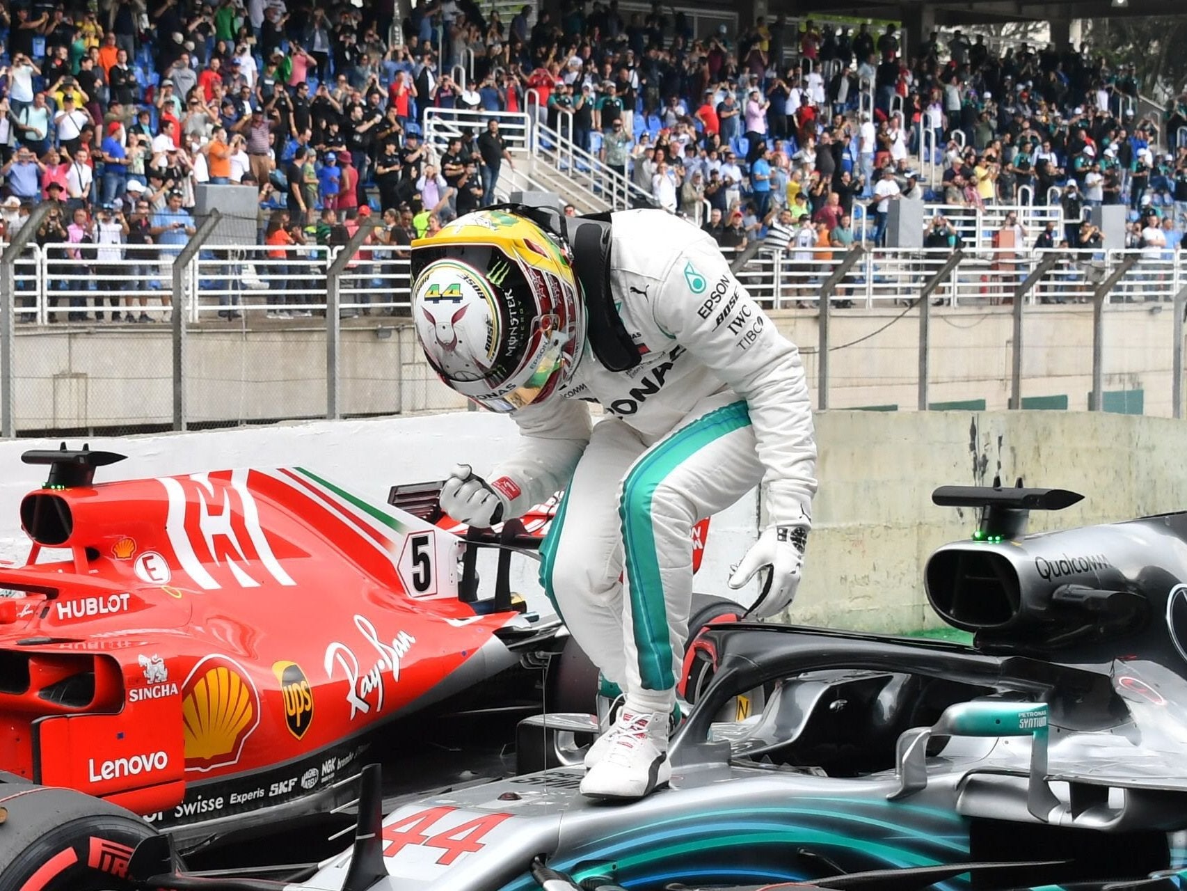 Lewis Hamilton celebrates on top of his Mercedes